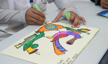 Student colours a bright abstract drawing